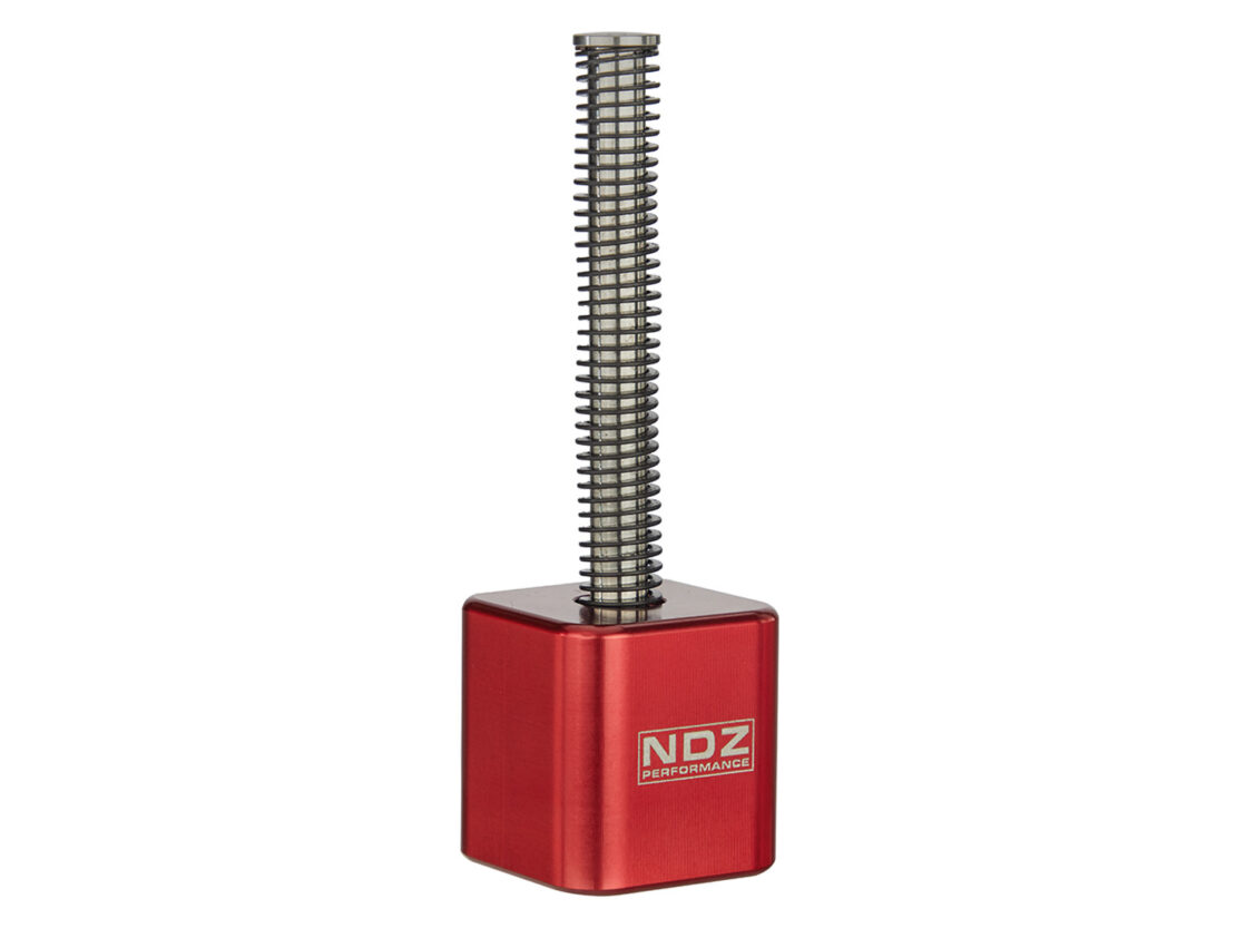 Red anodized guide rod tool with an extended spring, displaying the NDZ Performance branding on the side.