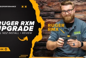 Justin of NDZ holding Ruger RXM pistol with NDZ Performance parts, alongside bold title text reading “Ruger RXM Upgrade – Full NDZ Install + Review.”