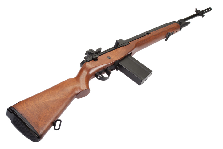 Walnut buttstock, trigger group and magazine well on a wood-stocked rifle