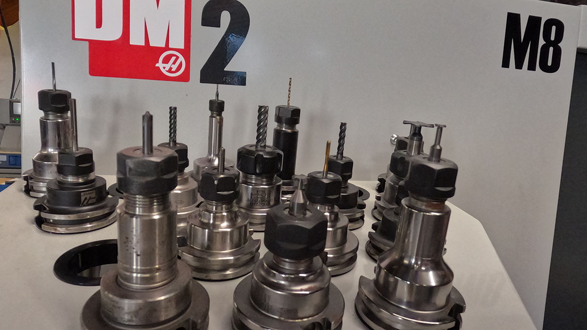 CNC tool holders lined up in front of a DM2 machining center in the NDZ shop