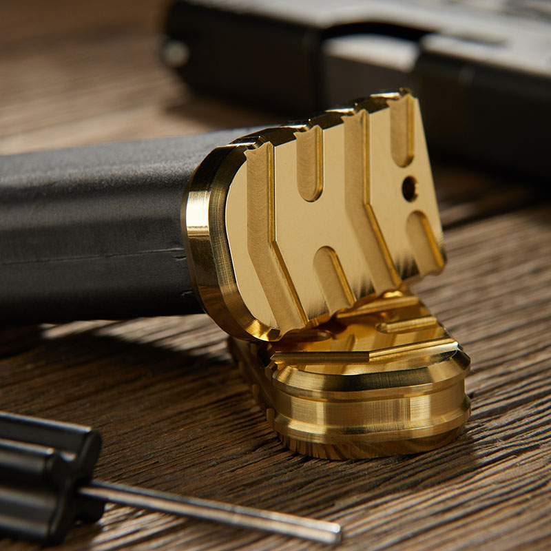 Brass magazine plate for the Glock 43X on a wooden bench