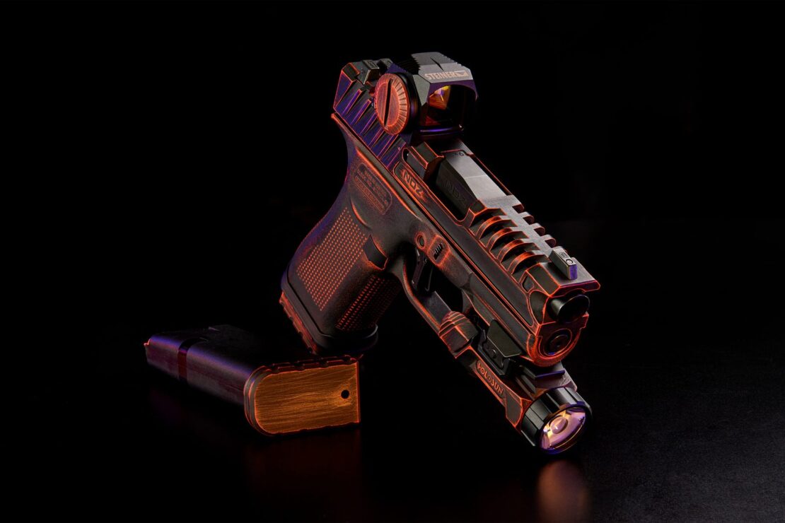The Glocktober giveaway build angled on a dark surface, with a magazine lying on its side beside it.